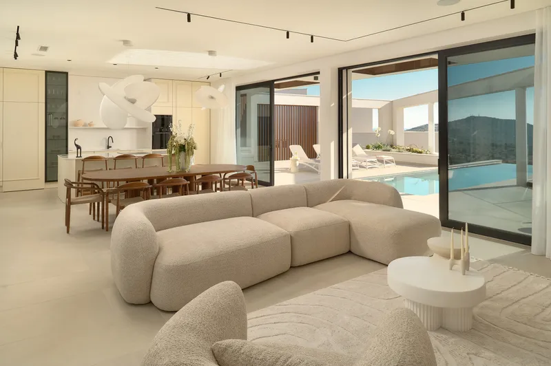 Luxury open plan living area with pool view at Villa Five K